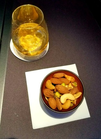 Cocktail and nuts in a bowl rather than packaged