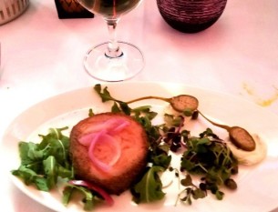 Smoked salmon ballotine with Italian cream cheese, capers, pickled onions, and arugula.